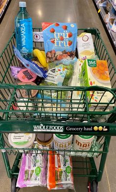 a shopping cart filled with groceries in a grocery store