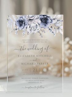 an elegant wedding card with blue flowers on it