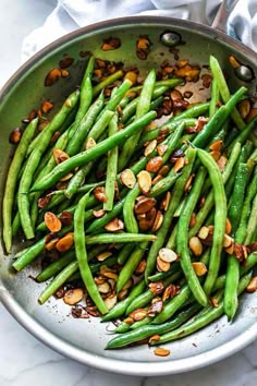 green beans and almonds in a pan on a table