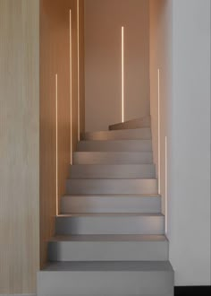 some white stairs with lights on them in a room