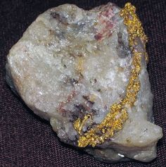 a rock with some gold chains on it