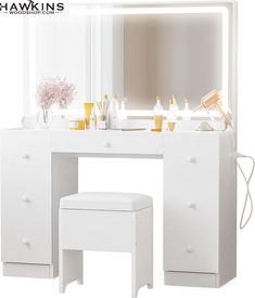 a white vanity table with stool and mirror