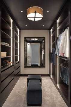 a walk - in closet with lights on the ceiling