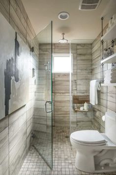 a bathroom with a toilet, sink and shower in it's stall area next to a walk - in shower