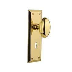 a brass door handle with an oval knob on it's side and a keyhole in the middle