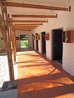 a row of black doors sitting next to each other on top of a wooden floor