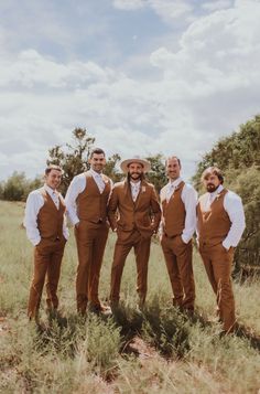 a group of men standing next to each other in a field