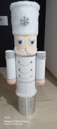 a fake nutcracker with blue eyes and a white hat on it's head