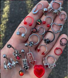 a person's hand holding many different types of rings in their palm, with the word love written on them