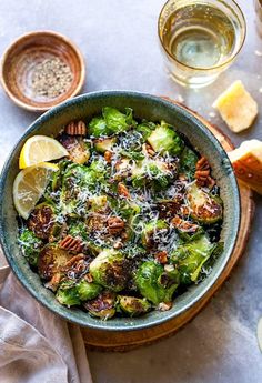 a bowl filled with brussel sprouts and topped with pecori