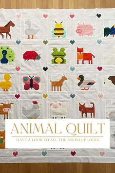 an animal quilt is displayed on a wooden surface with the title, animal quilt have a look to all the animal blocks