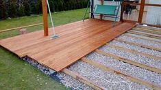 a wooden deck in the middle of a yard