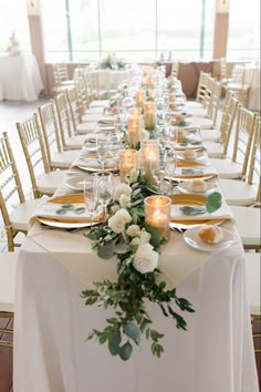 a long table is set with candles and plates