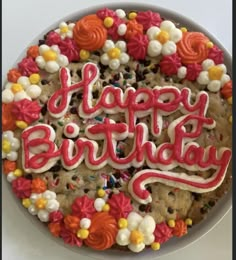 a happy birthday cookie decorated with flowers and icing