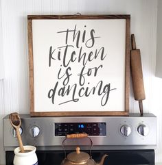 this kitchen is for dancing sign on the wall above an oven with a tea kettle