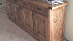 a large wooden cabinet sitting in the corner of a room