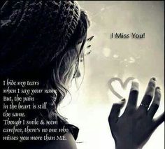 a woman holding a heart in her hand with the words i miss you on it