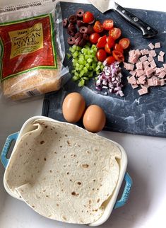 the ingredients are laid out on the counter to make tortilla bread, including tomatoes, olives, and other vegetables