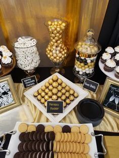 an assortment of desserts and candies displayed on a table