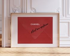 a red envelope with the words chanel written on it is in front of a white wall