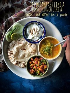 a white plate topped with different types of food on top of a blue table cloth