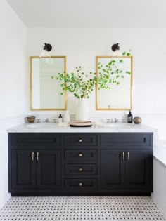 a bathroom with two sinks and mirrors on the wall