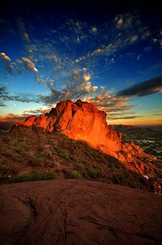 the sun is setting on top of a mountain