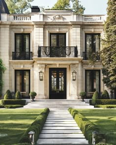 the front entrance to an elegant mansion with steps leading up to it's door