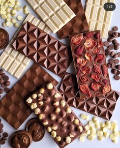 chocolates and candy are laid out on a white surface with different shapes and colors