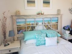 a bed with blue pillows and pictures on the headboard