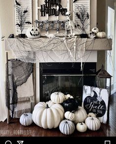 a fireplace decorated for halloween with white pumpkins