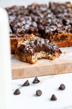 chocolate chip cookie bars cut in half on a cutting board