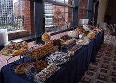 a buffet table filled with different types of pastries and desserts on top of it