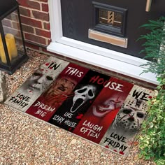 halloween doormats on the front steps of a house with scary faces and words