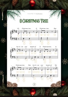 christmas tree sheet music with ornaments around it