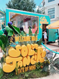 a sign that says welcome to the state of mind in front of a food truck
