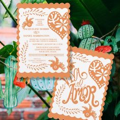 an orange and white wedding stationery with cactus