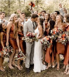 a group of people standing next to each other with flowers in their hair and dresses