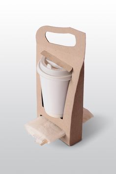 a cardboard box with a coffee cup in it