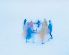 three people standing in the snow with their arms around each other