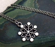 This is such a sweet and stylish silver snowflake pendant necklace.  It is the perfect everyday size, wear it all winter long!  It would make the perfect gift for any snow and winter loving person.  Pray for snow!The snowflake measures 5/8” long by 1/2” wide and hangs from a simple 18” stainless steel necklace chain with a lobster clasp.  I have matching earrings in my shop, if you would like the whole set!  Here is the link......... https://etsy.me/2AwKBzN Thanks for stopping by!  Please take a Silver Necklaces For Winter Holidays, Silver Pendant Necklace For Winter, Necklace Snowflake, Snowflake Necklace For Winter Holiday, Silver Snowflake Necklace, Nickel-free Snowflake Jewelry For Gift, Hunting Jewelry, Winter Snowflake Necklace, Winter Holiday Snowflake Necklace