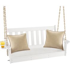 a white porch swing with two pillows on the back and one pillow on the front