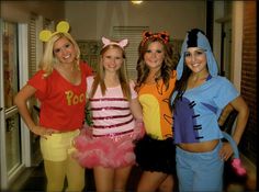 four girls in costumes posing for the camera