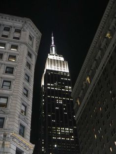 the empire building is lit up at night