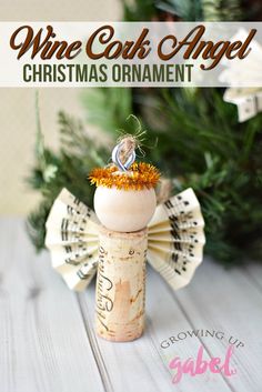 wine cork angel christmas ornament with an orange flower on top and the words, wine cork angel christmas ornament