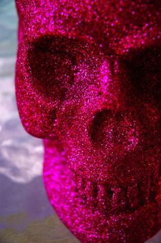 there is a red glitter skull in the water