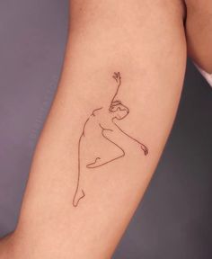 a woman's arm with a tattoo on it that has a line drawing of a girl