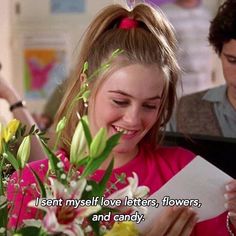 a girl is smiling and holding flowers in front of her with the caption, i sent my love letters, flowers, and candy