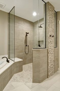 a large bathroom with a walk in shower next to a bathtub and separate sink