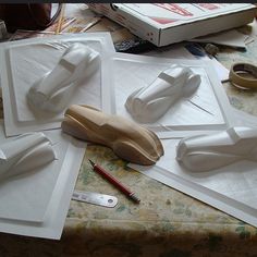 the table is covered with paper and wooden objects